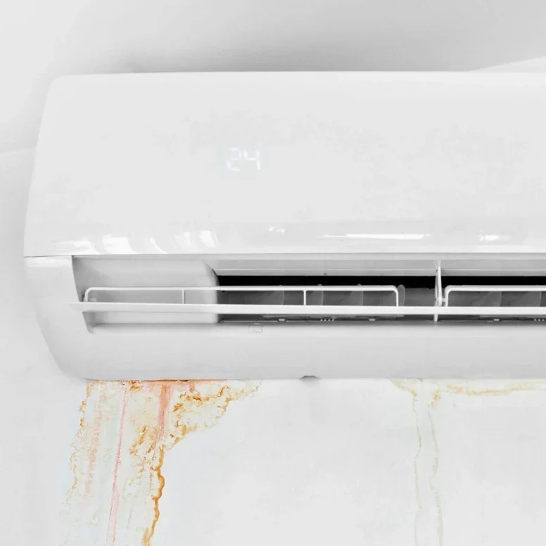 Water leaking from an indoor air conditioning unit in Douglas, AL, causing stains on the wall. This is a common AC issue, often caused by clogged drainage lines or refrigerant leaks, requiring professional repair.