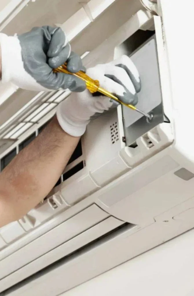 HVAC technician performing maintenance on an air conditioner in Douglas, AL, highlighting the importance of timely repairs for optimal cooling performance and efficiency.